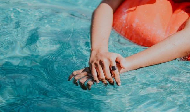 woman relaxes on a floatie in swimming pool